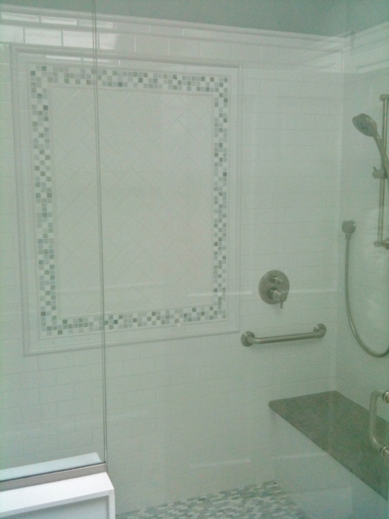 7 Foot stall shower with marble bench, and multiple shower heads.